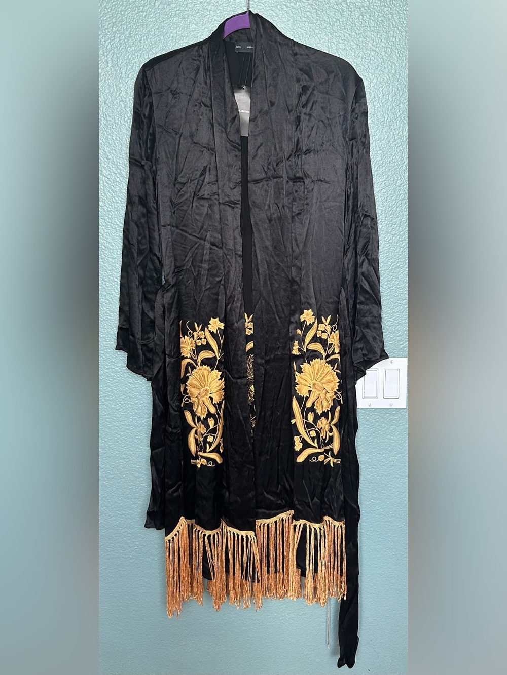 SFERA  black kimono featuring gold floral embroidery and fringed detailing.